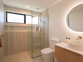 A bathroom with a shower, toilet, and sink at Sunderland Views - Clyde Holiday Home, Clyde