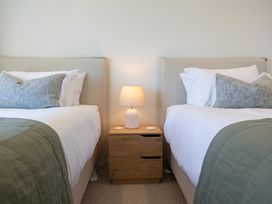 A bedroom with two beds and a nightstand in Sunderland Views - Clyde Holiday Home, Clyde