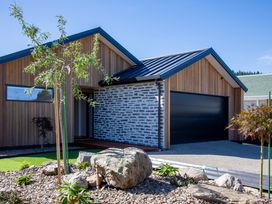 A modern house with a garage and landscape features at Sunderland Views - Clyde Holiday Home in Clyde