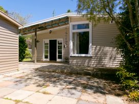 An outdoor area with a house and patio at The Trout House - Turangi Holiday Home, Turangi