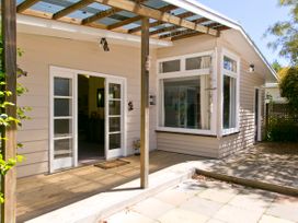 An outdoor area with patio and entrance door at The Trout House - Turangi Holiday Home, Turangi