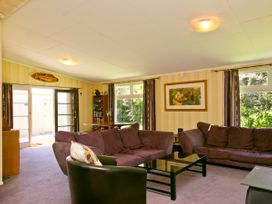 A living room with a sofa and coffee table at The Trout House - Turangi Holiday Home Turangi