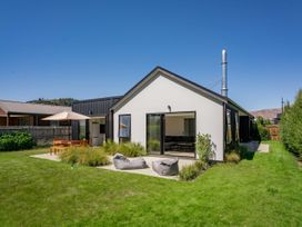 An outdoor area with a house and garden furniture at Northlake Hideaway - Wanaka
