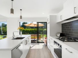 A kitchen with a sink and gas stove at Northlake Hideaway - Wanaka