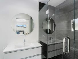 A bathroom with a shower and sink at Northlake Hideaway - Wanaka