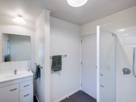 A bathroom with a sink and shower at Napier Holiday Home in Napier