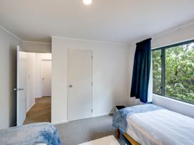 A bedroom with two beds and a window at Napier Holiday Home in Napier