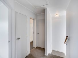 A hallway with multiple doors at Napier Holiday Home in Napier