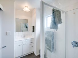 A bathroom with a sink and shower at Napier Holiday Home in Napier