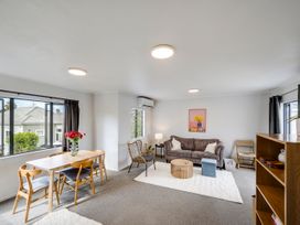 A living room with a table and chairs at Napier Holiday Home in Napier