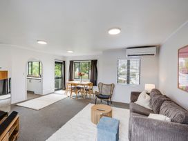 A living room with a dining table and sofa at Napier Holiday Home in Napier