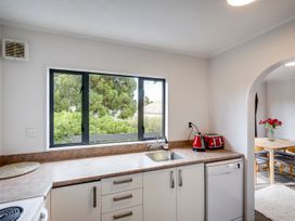 A kitchen with sink and window at Napier Holiday Home in Napier