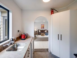 A kitchen with a sink, kettle and toaster at Napier Holiday Home in Napier