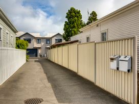 A driveway with fences and houses at Napier Holiday Home Napier