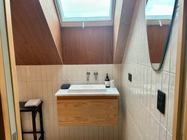 A bathroom with a sink and mirror at Cedarwood Retreat - Castle Hill