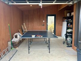 A game room with a ping pong table and a gas grill at Cedarwood Retreat - Castle Hill