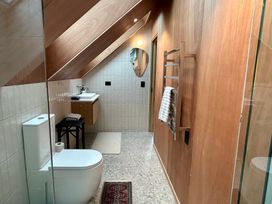 A bathroom with a sink, toilet, and towel rack at Cedarwood Retreat - Castle Hill Holiday Home, Castle Hill