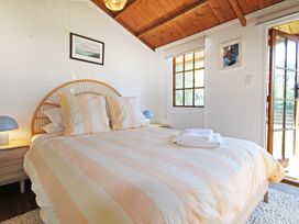 A bedroom with a bed and bedside tables at New Plymouth in New Plymouth