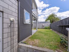 An outdoor area with a shower and grass at Whangamata Holiday Unit in Whangamata