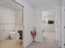 A bathroom with a toilet and sink at Whangamata Holiday Unit in Whangamata