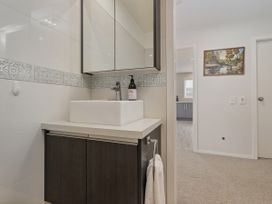 A bathroom with a sink and faucet at Whangamata Holiday Unit in Whangamata