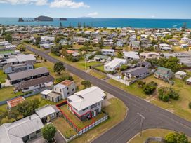 A house with a fence in a coastal neighborhood at Whangamata Holiday Unit Whangamata