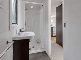 A bathroom with a sink and shower at Mangawhai Holiday Unit Kaiwaka