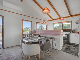 A dining room with a table and chairs at Pauanui Holiday Home in Pauanui