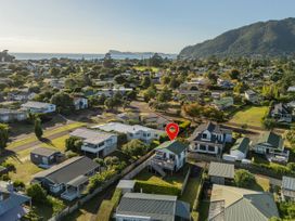 Aerial view of houses and ocean at Pauanui Holiday Home in Pauanui