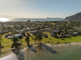 A view of houses and beach in Pauanui Holiday Home Pauanui