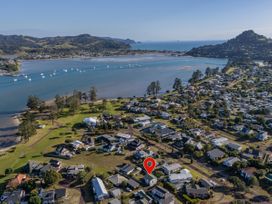 An aerial view of a coastal residential area near water at Pauanui Holiday Home Pauanui