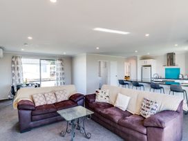 A living room with a sofa and coffee table at SeaRenity - Waimarama Holiday Home in Havelock North