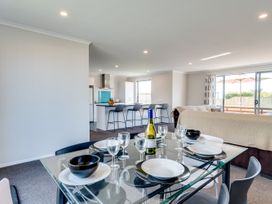 A dining area with a table set at SeaRenity - Waimarama Holiday Home Havelock North