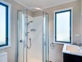 A bathroom with a shower and sink at SeaRenity - Waimarama Holiday Home, Havelock North