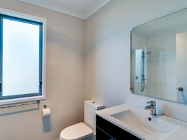 A bathroom with a sink, toilet, and shower at SeaRenity - Waimarama Holiday Home Havelock North
