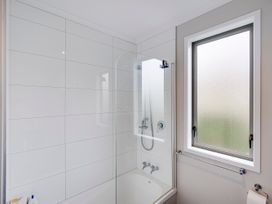 A bathroom with a shower and bathtub at SeaRenity - Waimarama Holiday Home in Waimarama