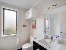 A bathroom with a sink, toilet, and shower at SeaRenity - Waimarama Holiday Home Waimarama