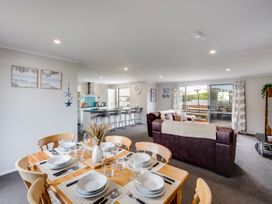 A dining area with table and chairs at SeaRenity - Waimarama Holiday Home Waimarama
