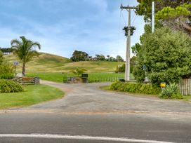 An outdoor entrance with a gravel road and greenery at SeaRenity - Waimarama Holiday Home Waimarama