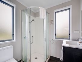 A bathroom featuring a shower, toilet, and sink at SeaRenity - Waimarama Holiday Home in Waimarama