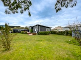 A house with a garden and deck at SeaRenity - Waimarama Holiday Home in Waimarama