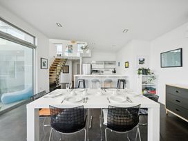 A dining room with a table set at Peka Peka Beach House - Waikanae