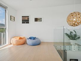A snug with bean bags and wall art at Peka Peka Beach House - Waikanae