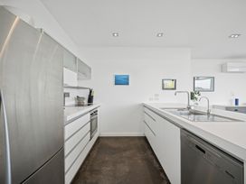 A kitchen with modern appliances at Peka Peka Beach House - Waikanae Holiday Home Waikanae