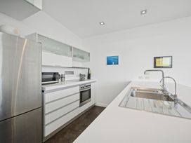 A kitchen with appliances and counter space at Peka Peka Beach House - Waikanae