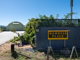 An outdoor view with a sign and a building at Hawksie Place in Reporoa