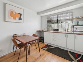 A kitchen with a table and chairs at Hawksie Place in Reporoa