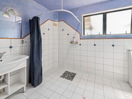 A bathroom with a shower and sink at Hawksie Place in Rep Fiji