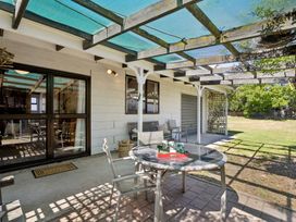 An outdoor area with a table and chairs at Wanaka Holiday Home in Wanaka