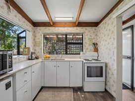 A kitchen with a sink and stove at Wanaka Holiday Home in Wanaka